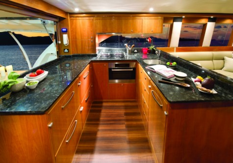 The aft galley with awning window is perfect for alfresco dinning in the cockpit Shown here in high gloss cherry cabinetry